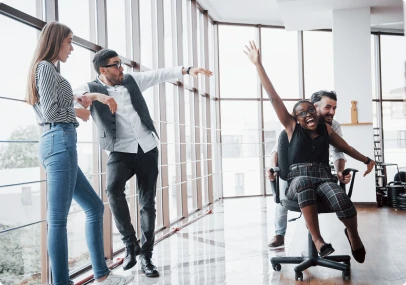 A group of business people having fun, at the office.